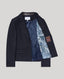 Navy blazer with blue lining on a light gray background