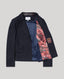 Navy blazer with coral lining on a light gray background