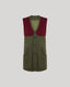 A sleeveless button-front vest in olive green wool with contrasting dark red velvet shoulder panels and matching red piping along the pocket edges, shown on a light gray background.