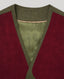 Close-up of a wrap-style cardigan featuring deep burgundy suede-like panels and olive green wool trim, with a matching olive green inner lining.