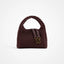 A small structured handbag with a rounded top handle, covered in a dark burgundy textured woven pattern, featuring a matching leather strap with gold-tone hardware on a clean white background.