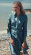 Video of model in blue silk gown on the beach